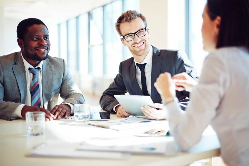 Executive holding tablet in meeting