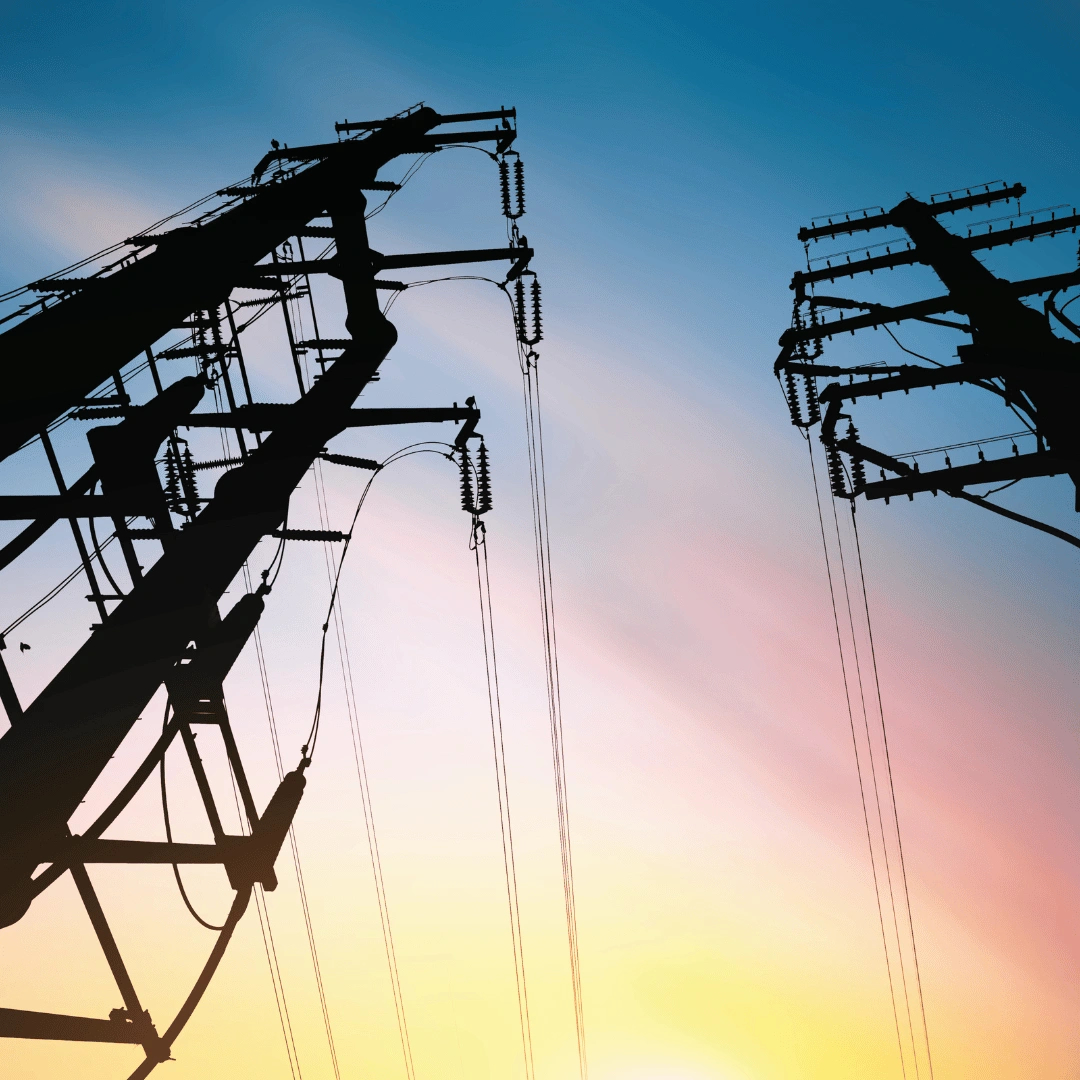 Electrical power lines against a colorful sky