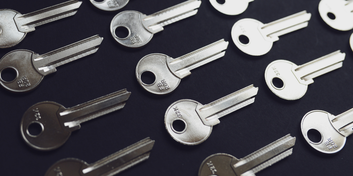 Silver keys on a dark background.