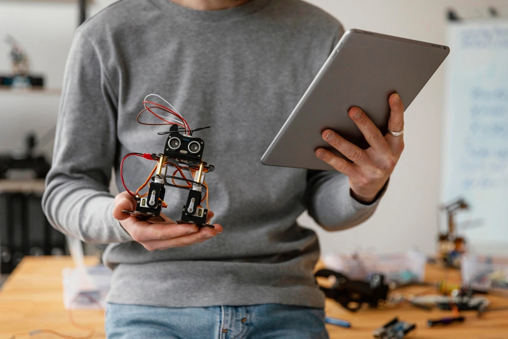 Man holding robot and tablet