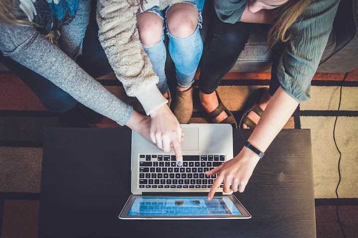 friends gathered around a computer