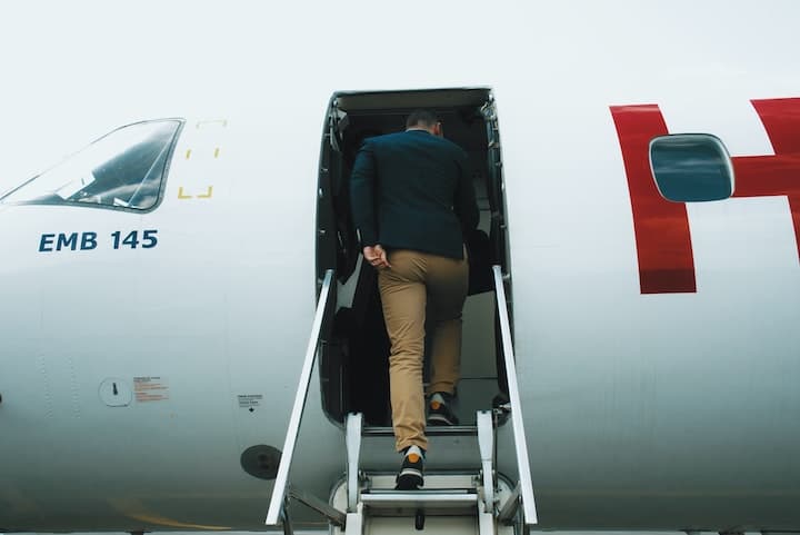 passenger using steps to board an airplane