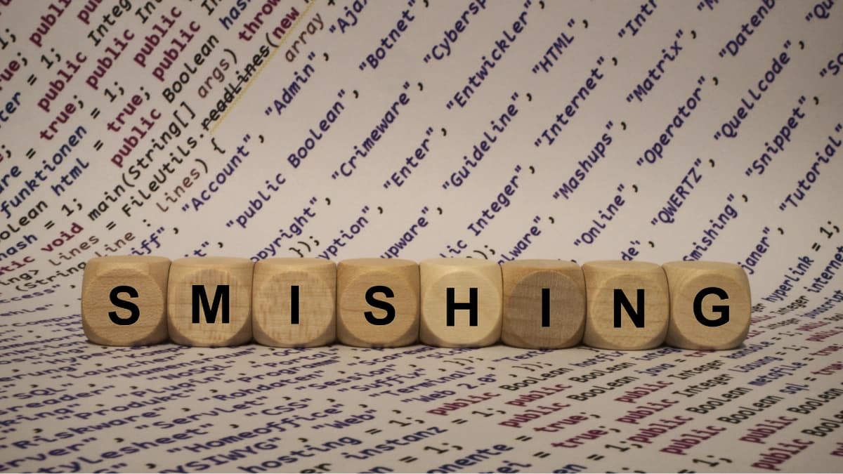 The word smishing in letter blocks with text in the background.